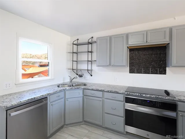 a kitchen with a refrigerator sink and stainless steel appliances