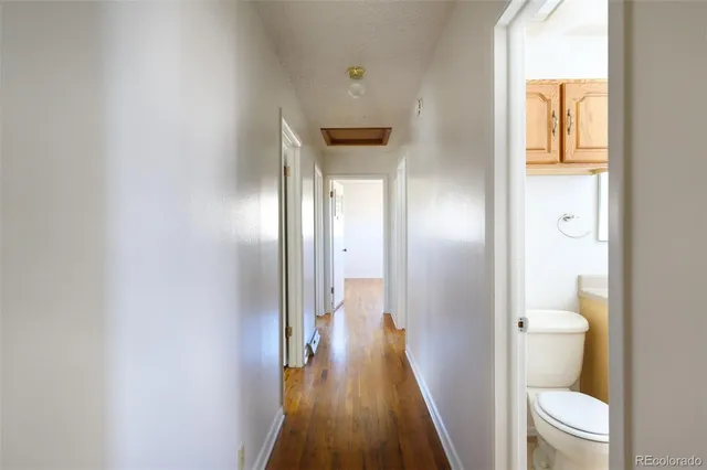 a view of empty room with wooden floor