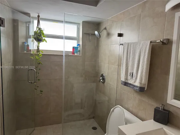 a bathroom with a shower and a window