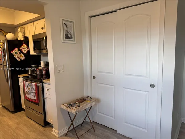 a kitchen with granite countertop a stove a sink and a refrigerator