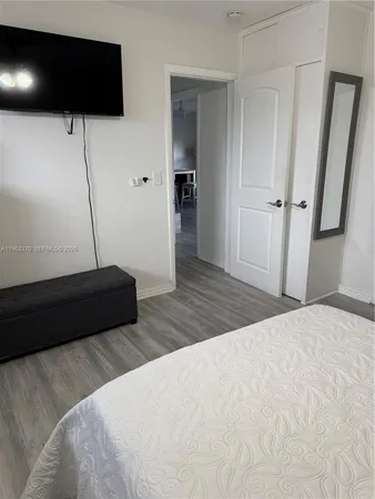 a bed sitting in a bedroom next to a small yard