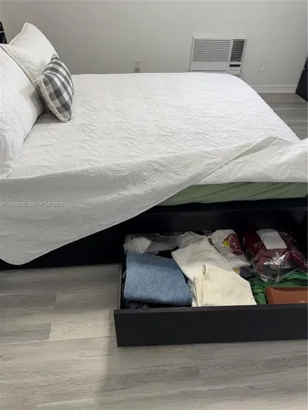 a bed sitting in a bedroom and dresser