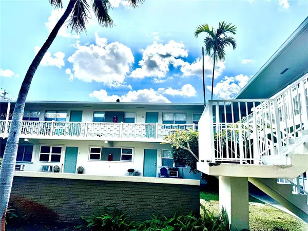 a view of a house with swimming pool and sitting area