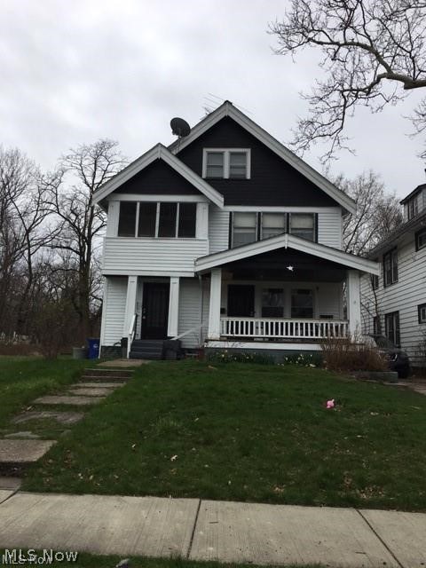 Two-story residence with white siding and dark gables