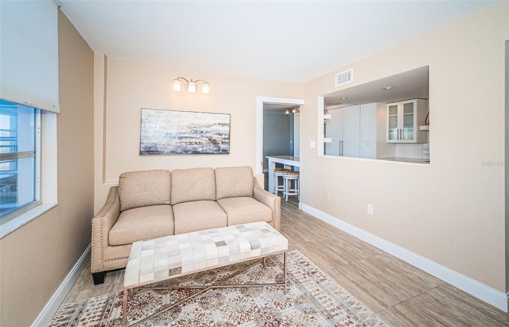 634 Edgewater Drive, Unit 447 Dunedin, FL 34698 - Photo 30 of 53 a bedroom with a large bed and a couch