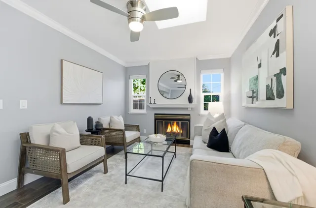 a living room with furniture a clock and a fireplace