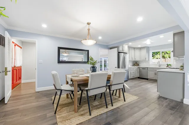 a view of a dining room with furniture and wooden floor