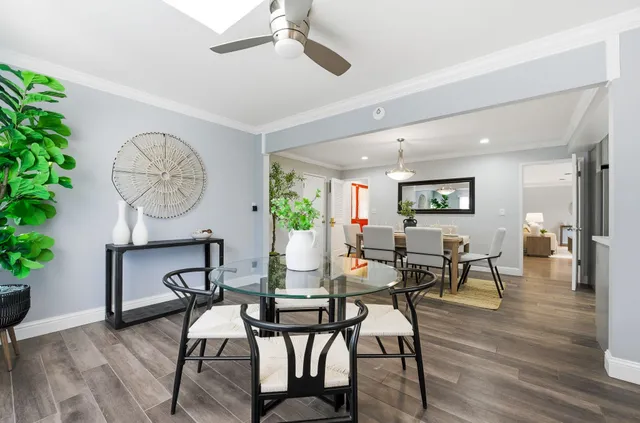 a view of a dining room with furniture and wooden floor