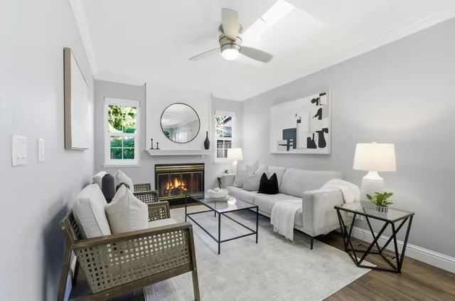 a living room with furniture a fireplace and window
