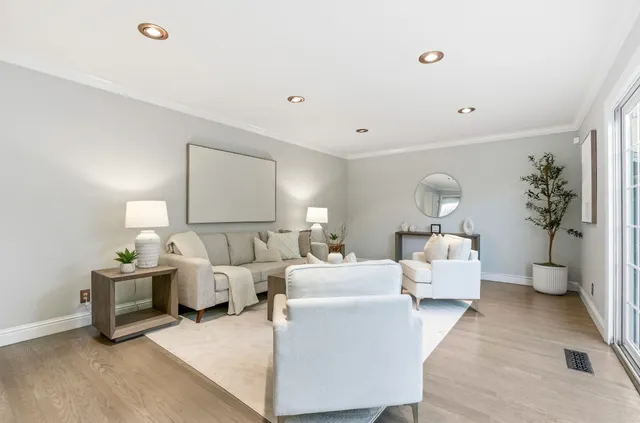 a living room with furniture and a lamp