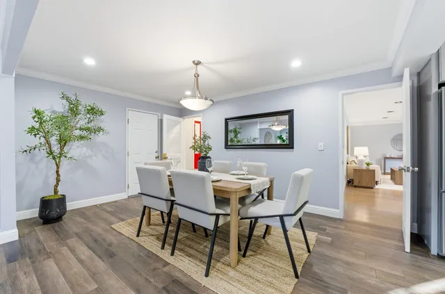 a view of a dining room with furniture and a chandelier