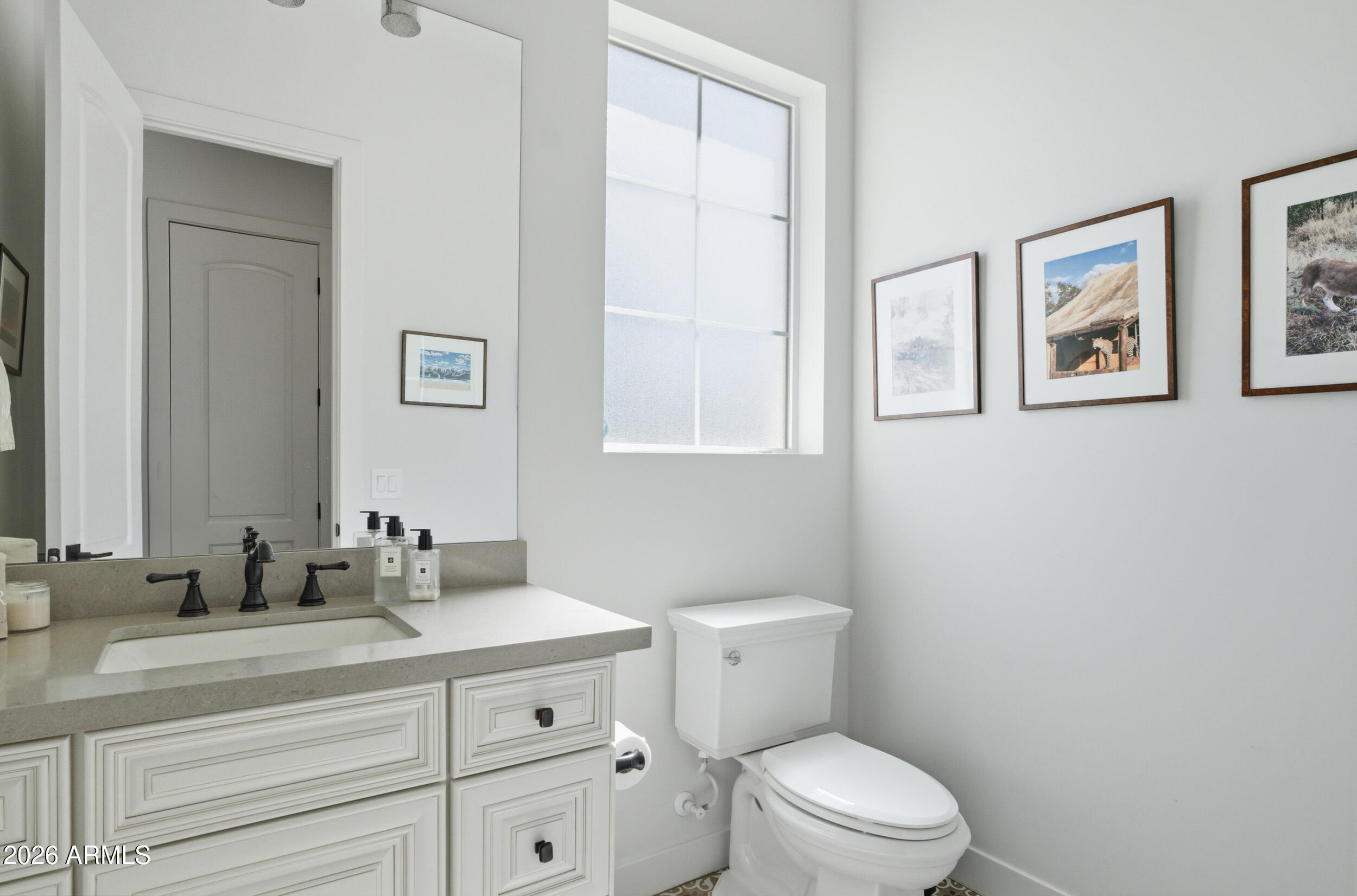 40 West Frier Drive Phoenix, AZ 85021 - Photo 18 of 54 a bathroom with a toilet a sink and mirror