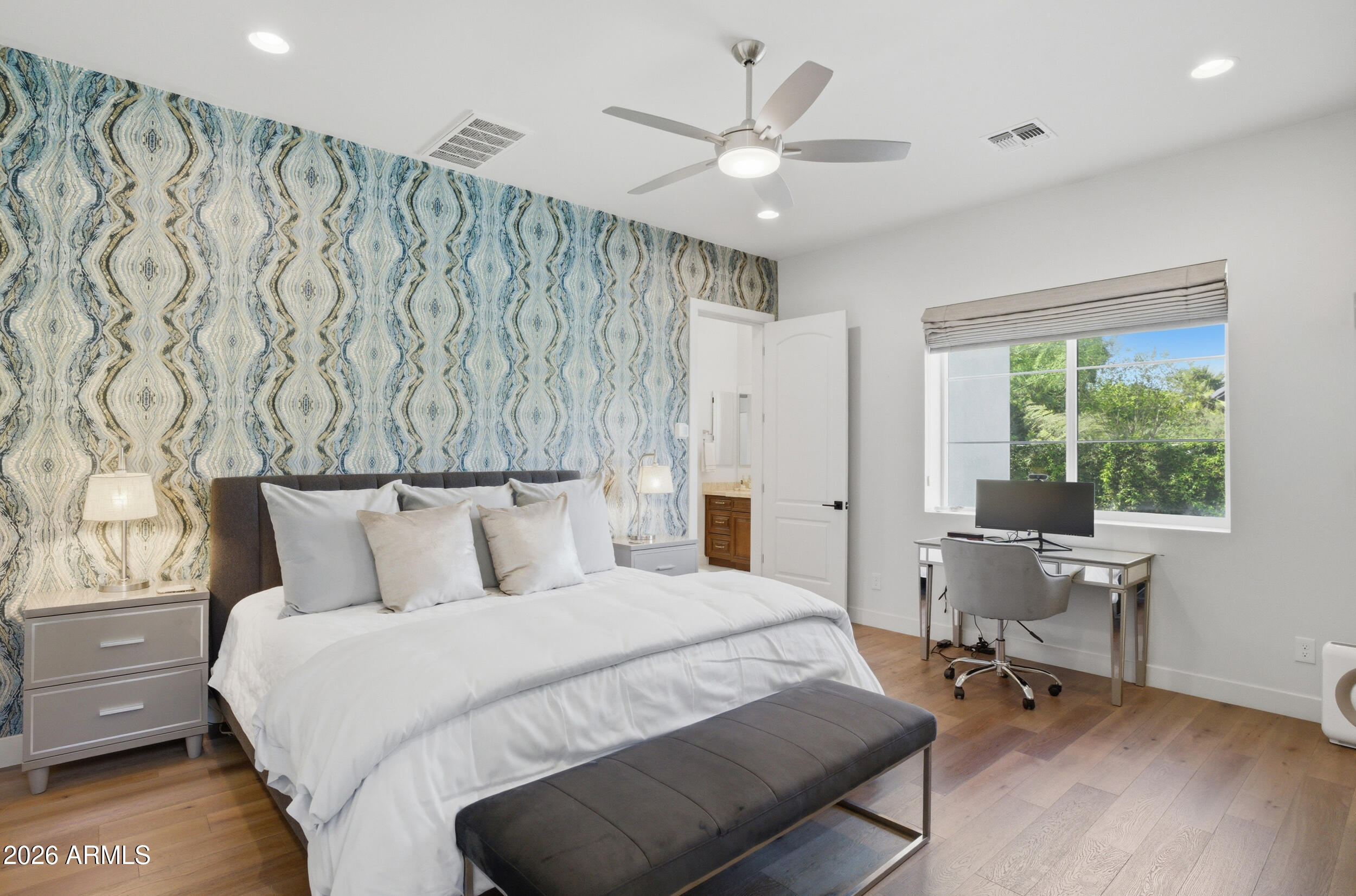 40 West Frier Drive Phoenix, AZ 85021 - Photo 19 of 54 a bedroom with a large bed and a chandelier