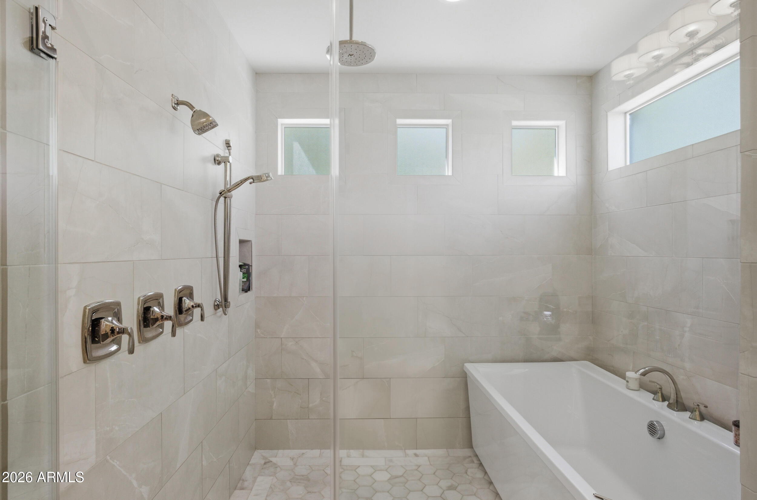 40 West Frier Drive Phoenix, AZ 85021 - Photo 21 of 54 a bathroom with a bathtub and shower