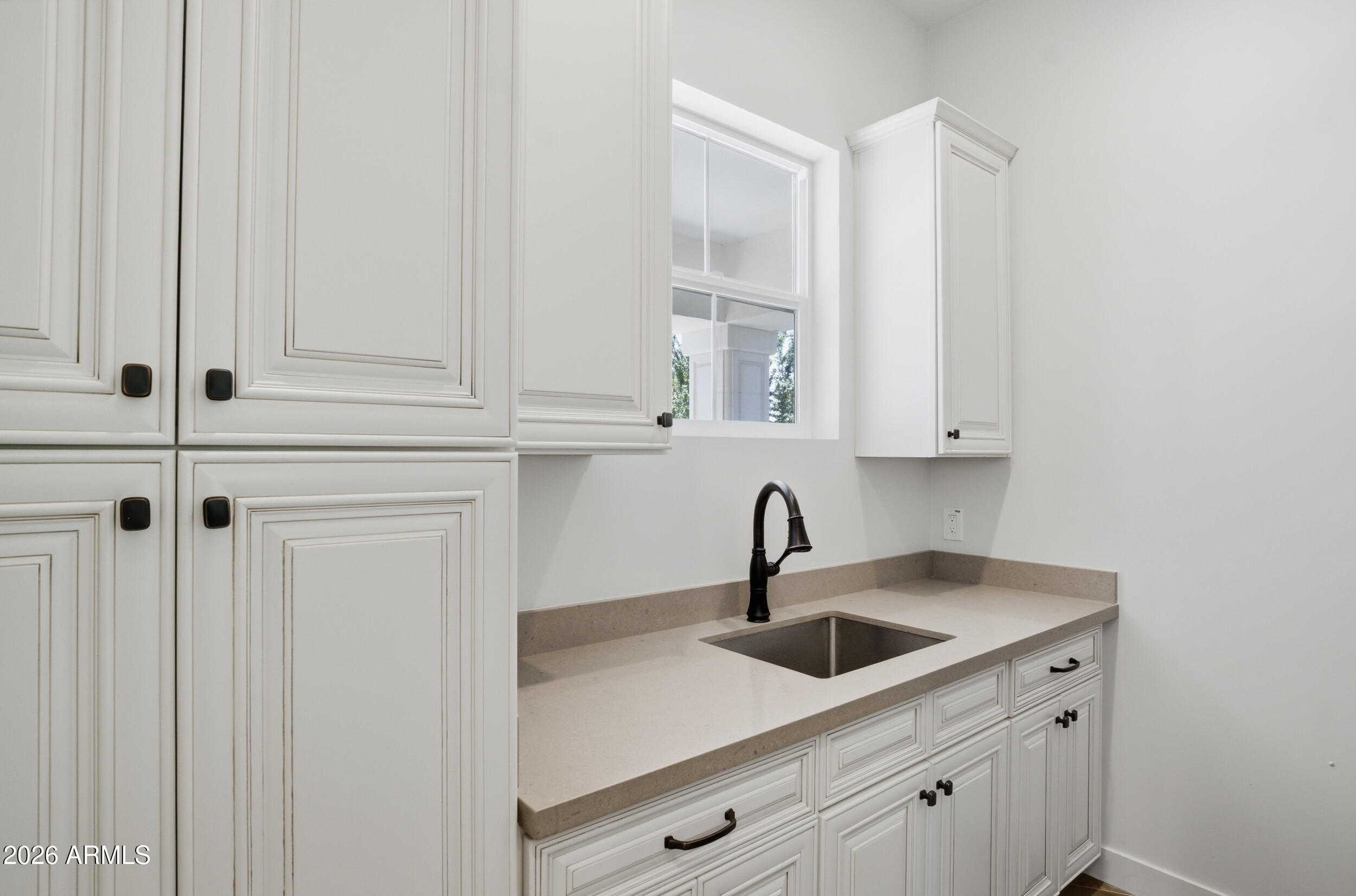 40 West Frier Drive Phoenix, AZ 85021 - Photo 32 of 54 a kitchen with white cabinets and sink