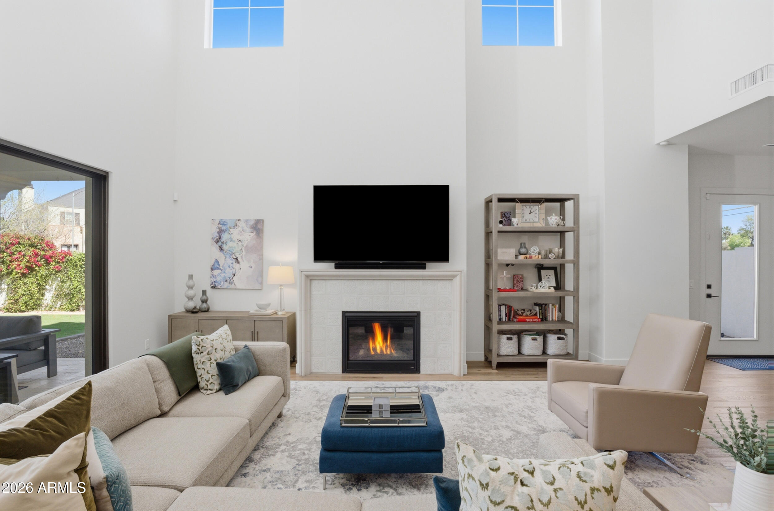 40 West Frier Drive Phoenix, AZ 85021 - Photo 6 of 54 a living room with furniture a flat screen tv and a fireplace