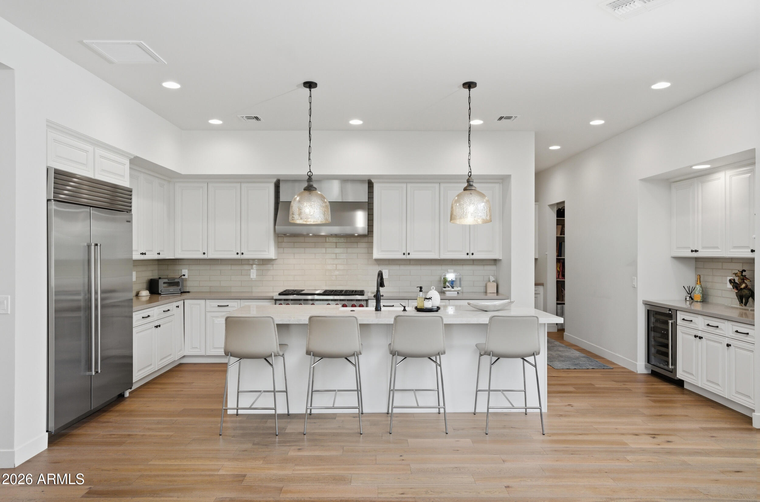 40 West Frier Drive Phoenix, AZ 85021 - Photo 9 of 54 a kitchen with stainless steel appliances granite countertop a kitchen island hardwood floor sink stove dining table and chairs