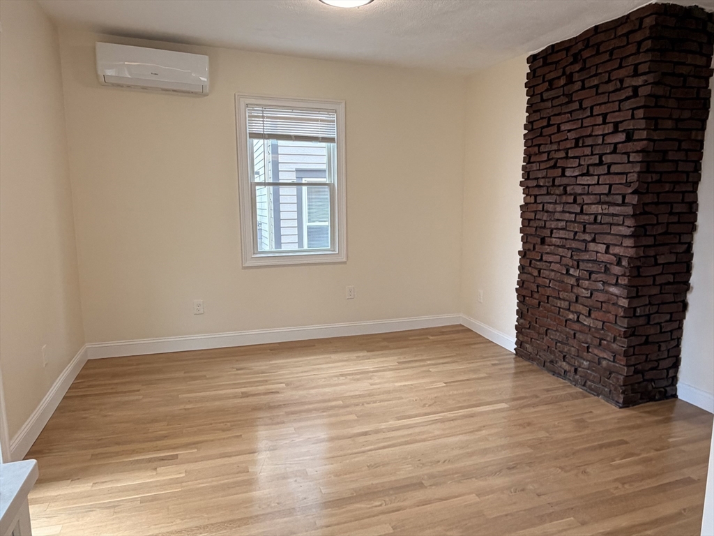 26 Brooks Street, Unit 2 Boston, MA 02128 - Photo 4 of 12 a view of empty room with wooden floor and windows