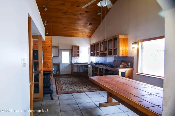a kitchen with stainless steel appliances granite countertop a barbecue grill and cabinets