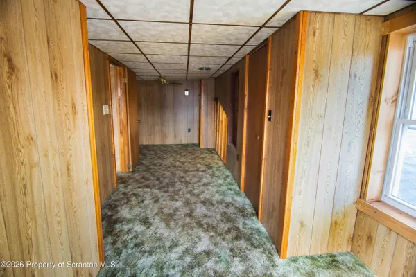 a view of a hallway with wooden door