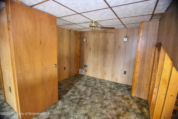 a view of room with wooden door
