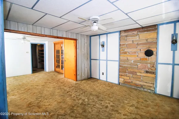 a view of an empty room with a ceiling fan