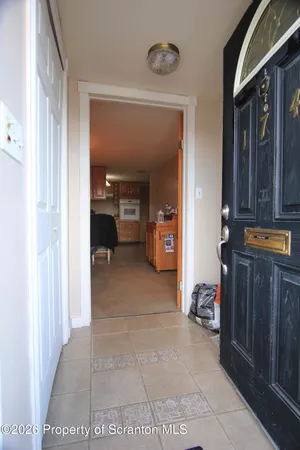 a view of living room filled with furniture and baby crib