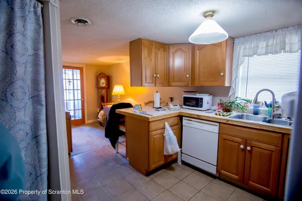 a kitchen with cabinets a sink and appliances