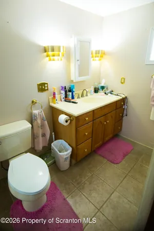 a bathroom with a sink mirror vanity and toilet