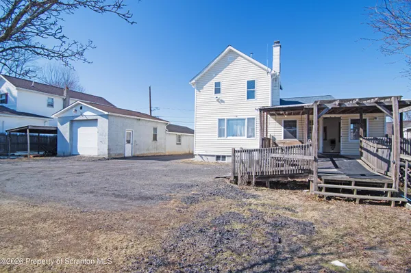a view of a house with a backyard