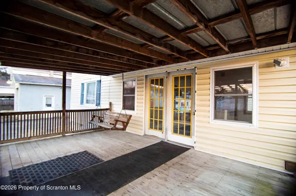 a view of a porch with wooden floor