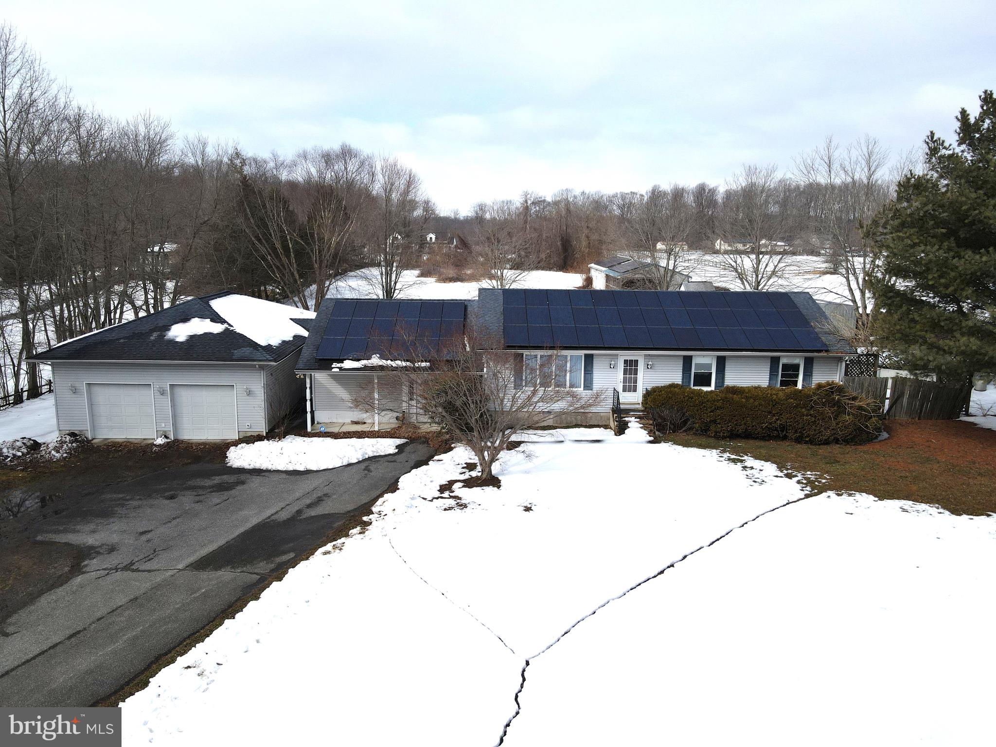a view of a house with snow on the road