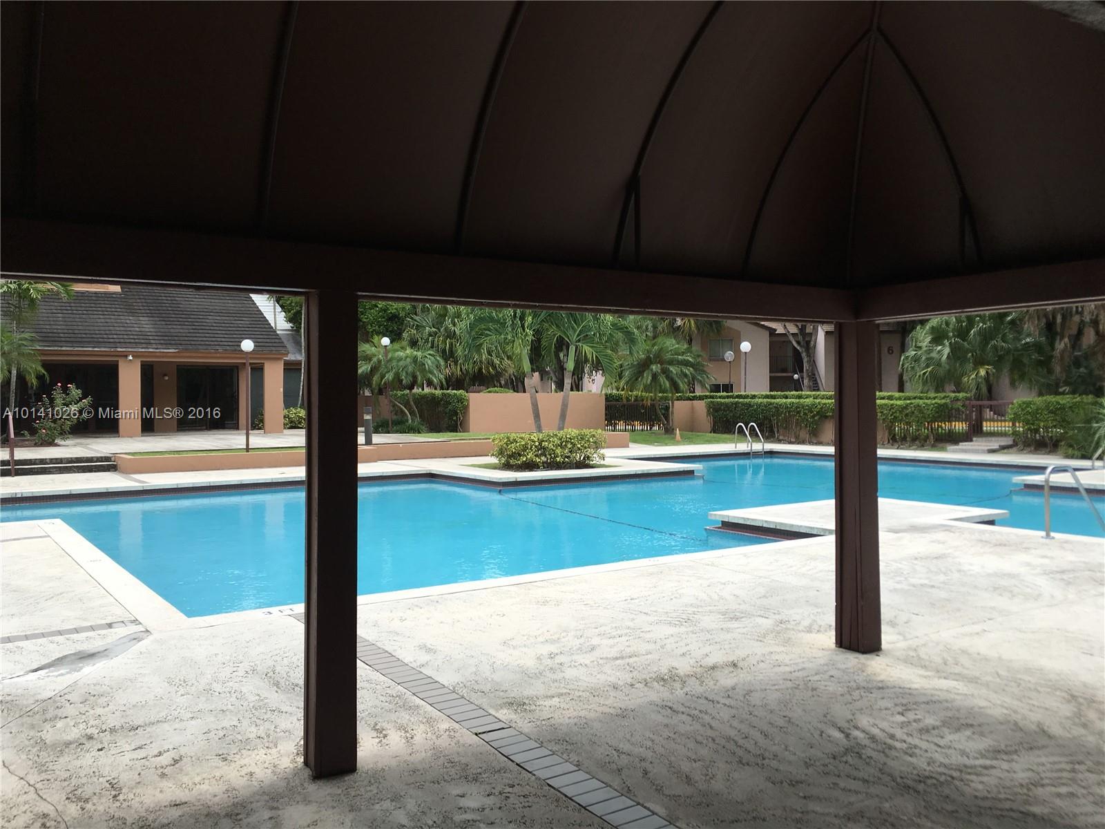 13946 Southwest 90th Terrace, Unit 13946 Miami, FL 33186 - Photo 16 of 16 a view of a swimming pool with a porch