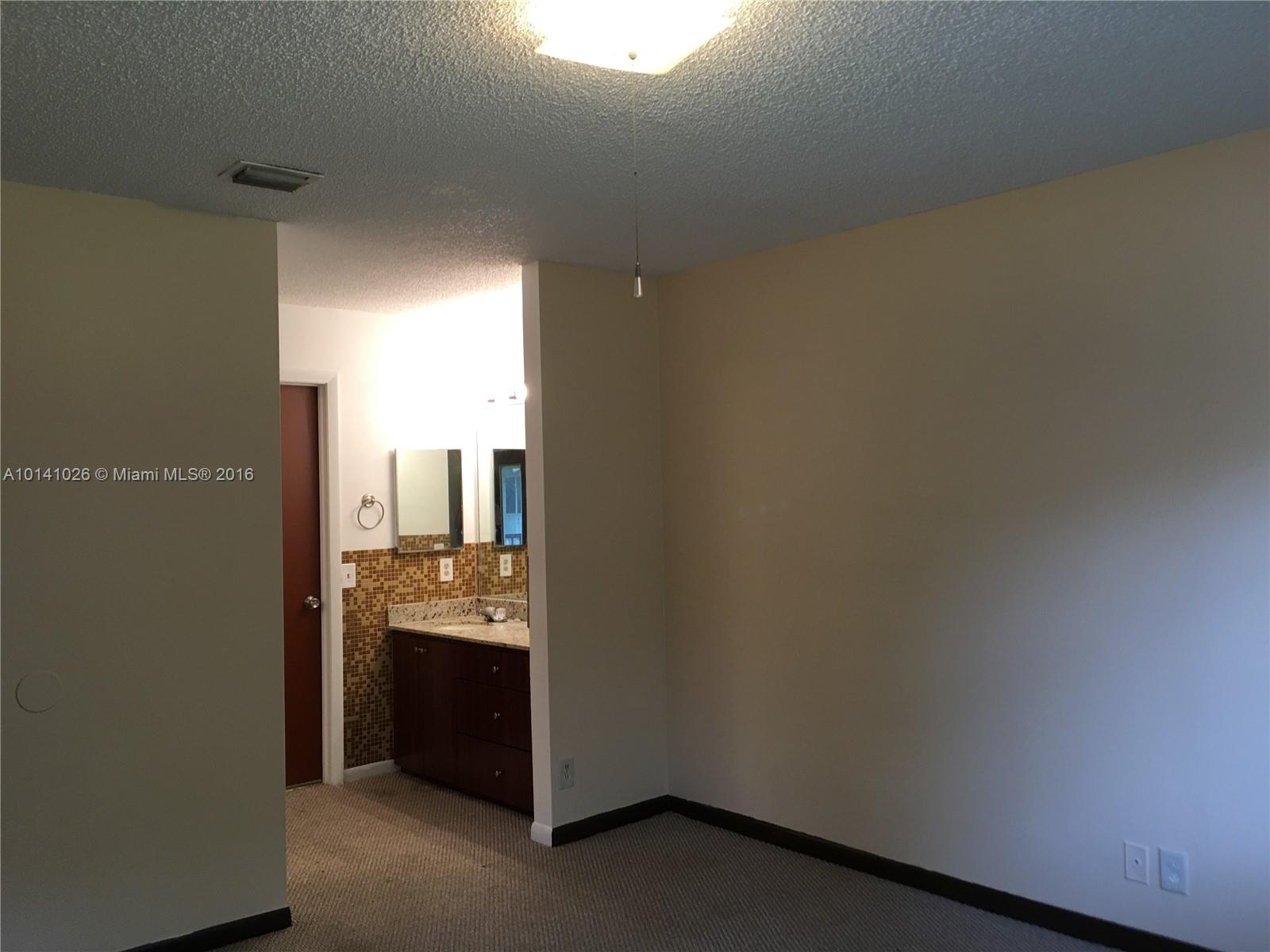 13946 Southwest 90th Terrace, Unit 13946 Miami, FL 33186 - Photo 3 of 16 a bathroom with a sink and a mirror