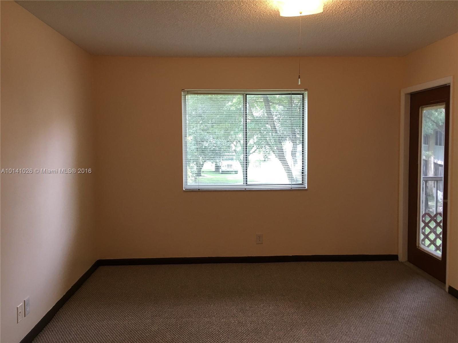 13946 Southwest 90th Terrace, Unit 13946 Miami, FL 33186 - Photo 5 of 16 an empty room with a window