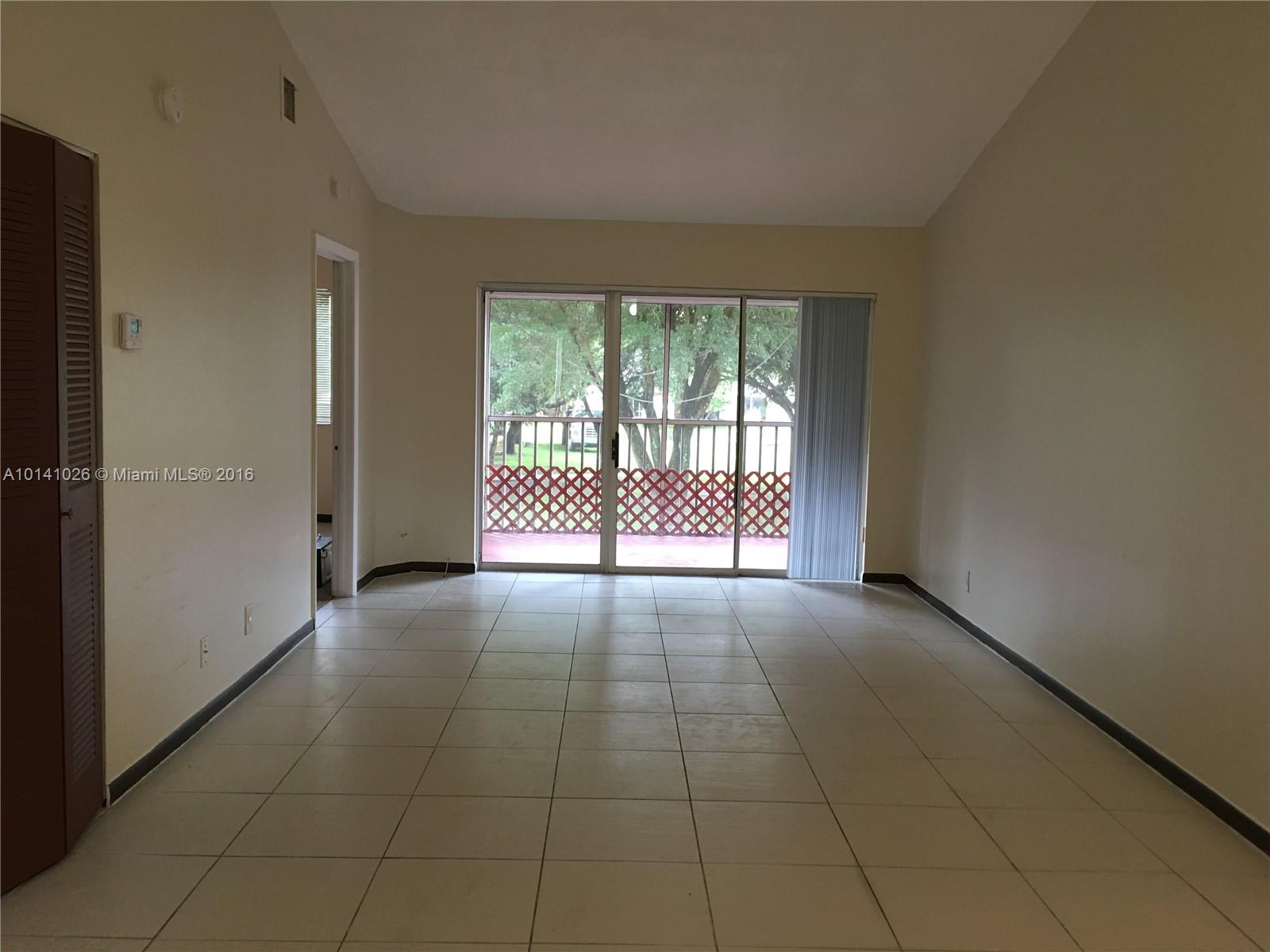 13946 Southwest 90th Terrace, Unit 13946 Miami, FL 33186 - Photo 8 of 16 a view of an empty room with a window