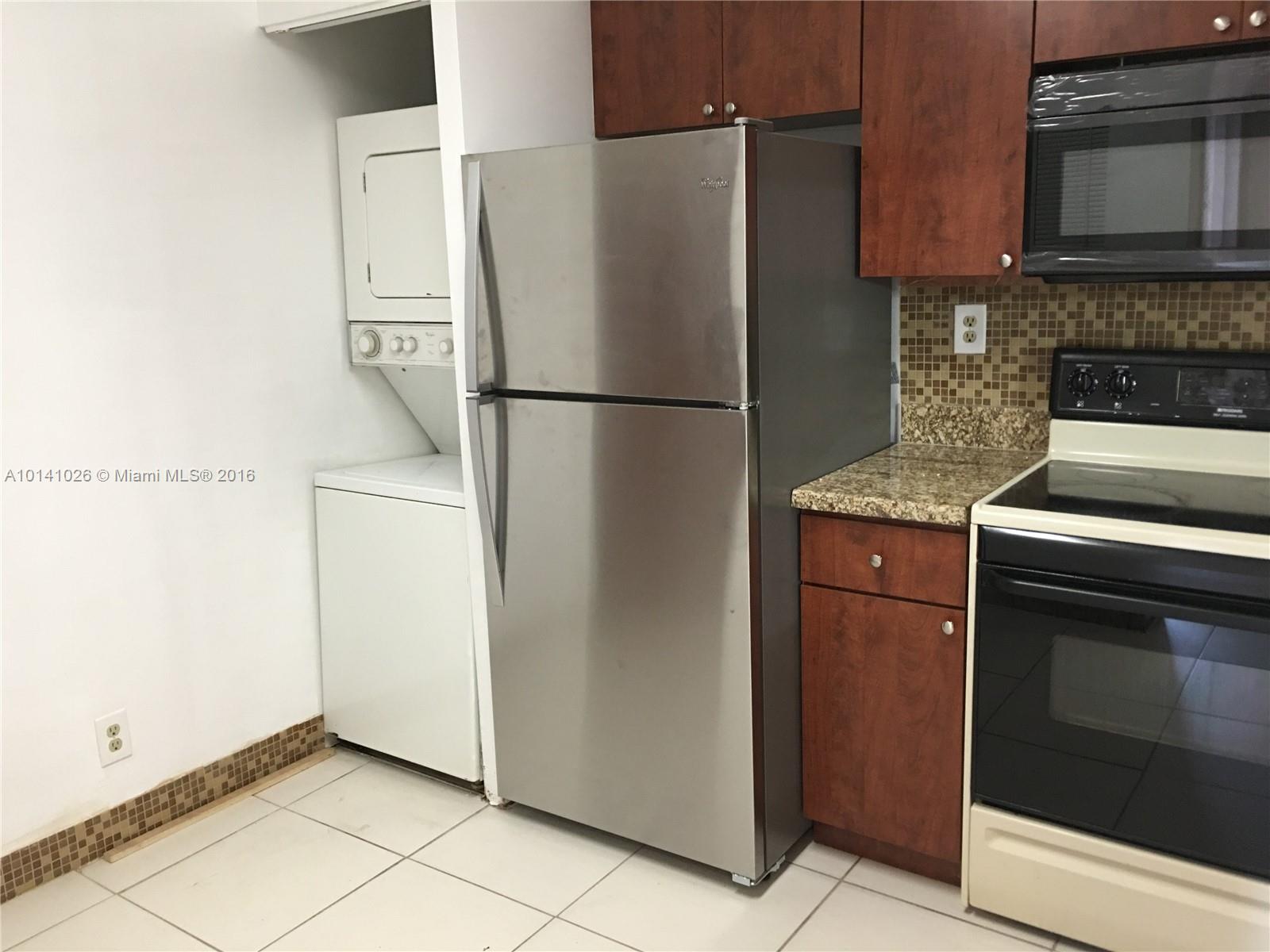 13946 Southwest 90th Terrace, Unit 13946 Miami, FL 33186 - Photo 10 of 16 a kitchen with metallic refrigerator freezer and a dishwasher