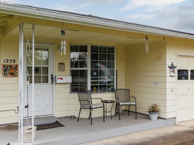 a couple of chairs in front of window