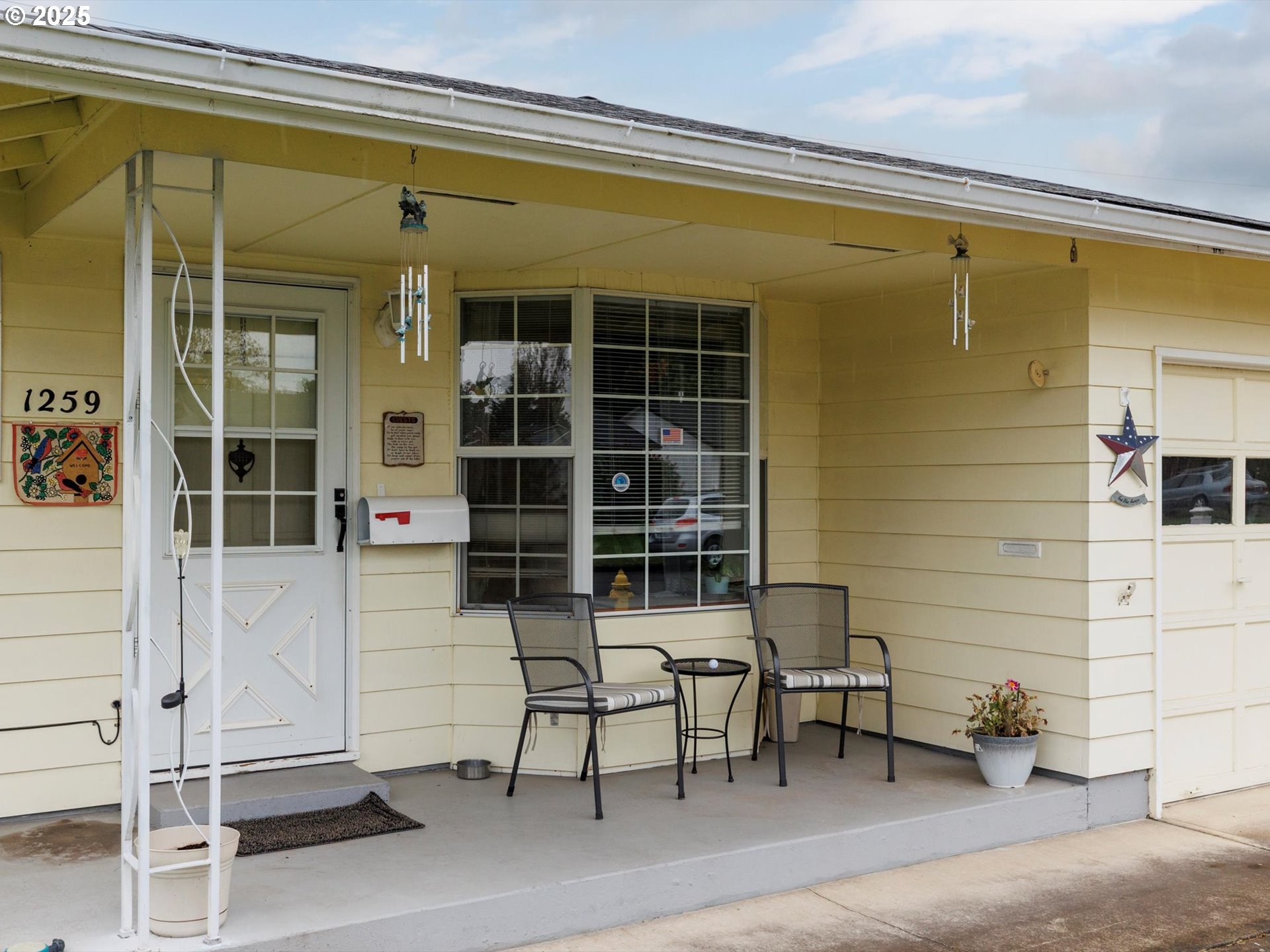 a couple of chairs in front of window