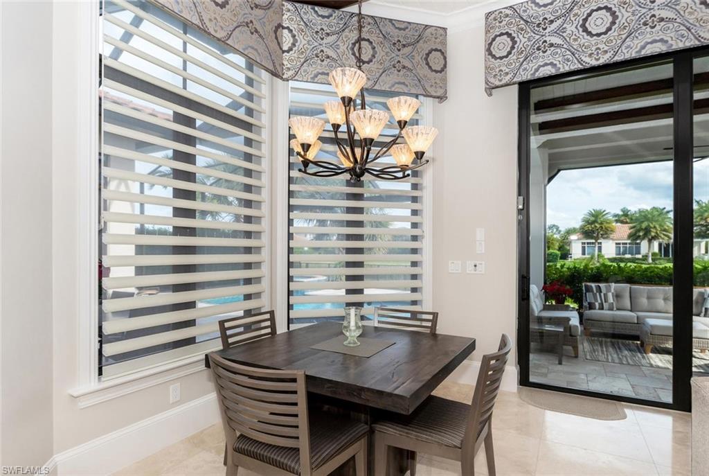 2220 Residence Circle Naples, FL 34105 - Photo 11 of 30 a view of a dining room with furniture and a window