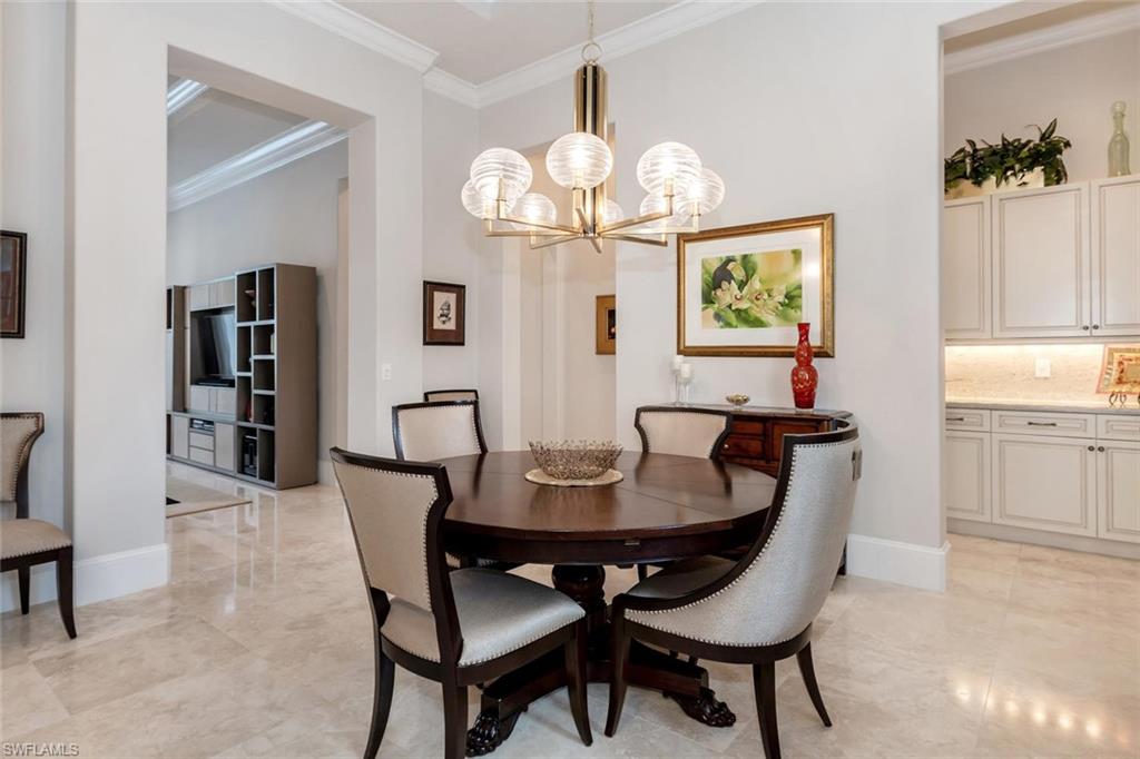 2220 Residence Circle Naples, FL 34105 - Photo 20 of 30 a view of a dining room with furniture and chandelier