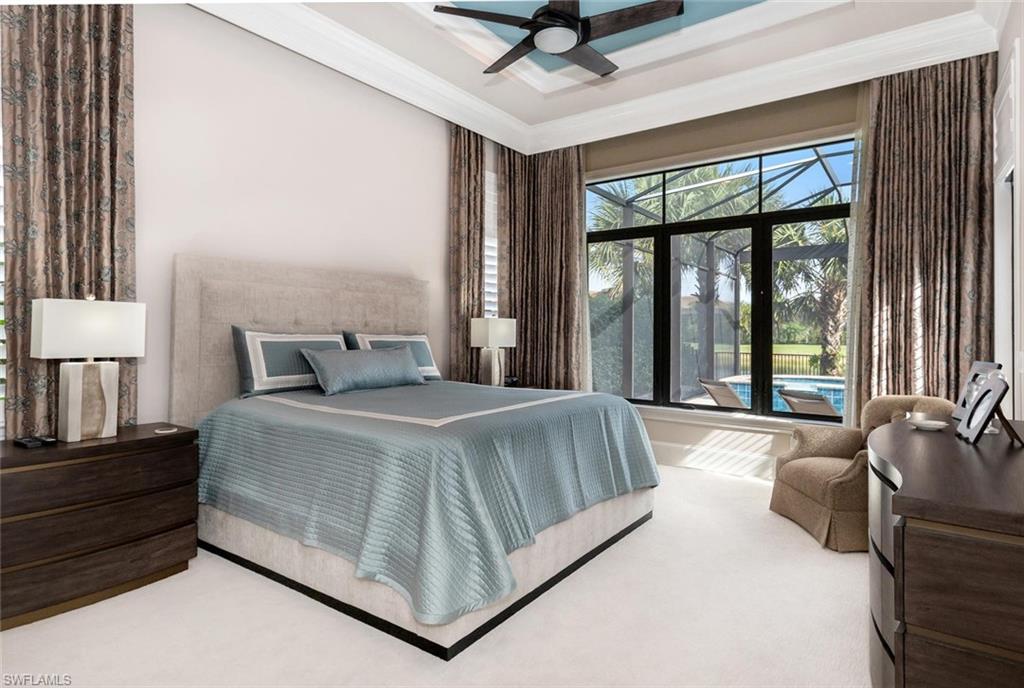 2220 Residence Circle Naples, FL 34105 - Photo 22 of 30 a bedroom with a large bed and a large window