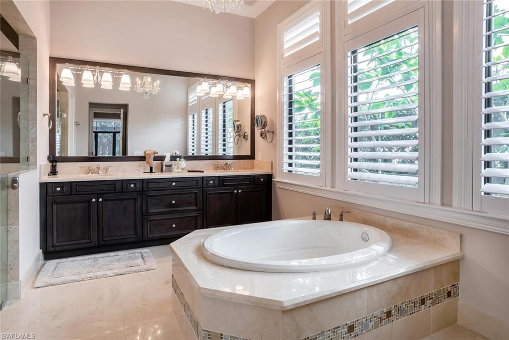 2220 Residence Circle Naples, FL 34105 - Photo 23 of 30 a bathroom with a sink and a mirror