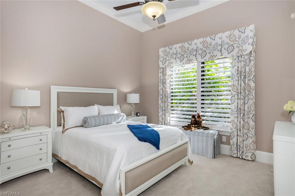 2220 Residence Circle Naples, FL 34105 - Photo 26 of 30 a bedroom with a bed and a chandelier