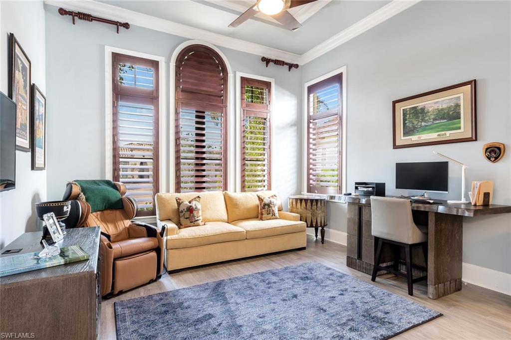 2220 Residence Circle Naples, FL 34105 - Photo 28 of 30 a living room with furniture fireplace and a large window