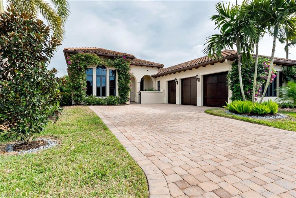 2220 Residence Circle Naples, FL 34105 - Photo 30 of 30 front view of a house with a yard and potted plants