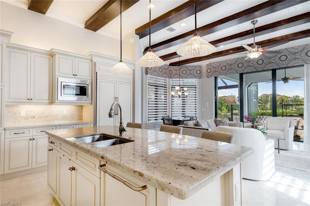 2220 Residence Circle Naples, FL 34105 - Photo 3 of 30 a kitchen with stainless steel appliances granite countertop a sink and a counter space