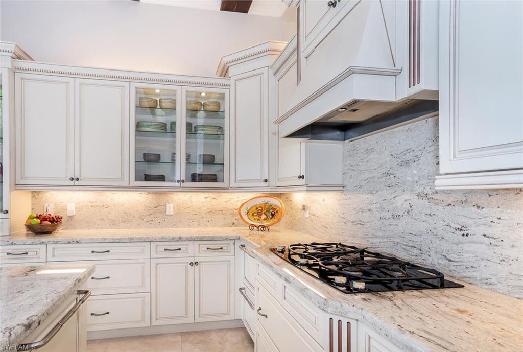 2220 Residence Circle Naples, FL 34105 - Photo 9 of 30 a kitchen with stainless steel appliances granite countertop a stove and a sink