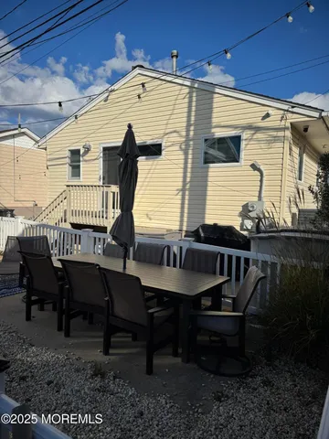 a balcony with table and chairs