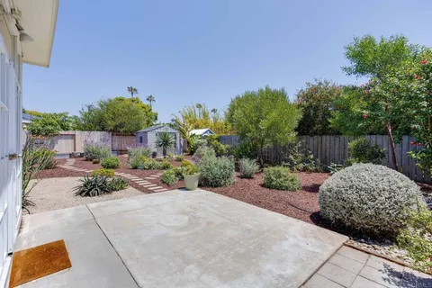 a view of a backyard with sitting area